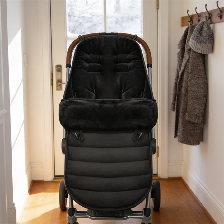 Black bunting bag fitted in an empty stroller by the front door