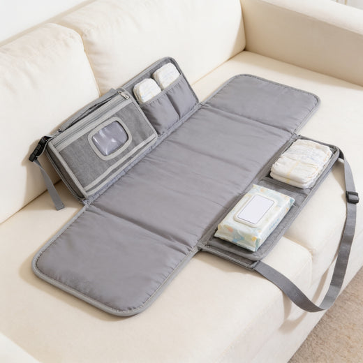 Lumiwee Robin portable changing pad: gray portable changing pad unfolded on a sofa