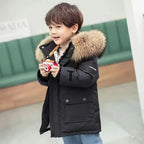 Boys winter coat with hood in black, worn by a boy holding a toy camera, fluffy hood trim and snap-flap pocket