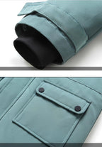 Boys winter coat close-ups in teal: black knit inner cuff tucked inside the sleeve, and a snap-flap front pocket