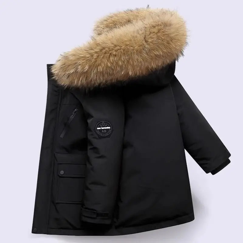 Boys winter coat with hood in black, side view with fluffy hood trim, chest zip and sleeve patch