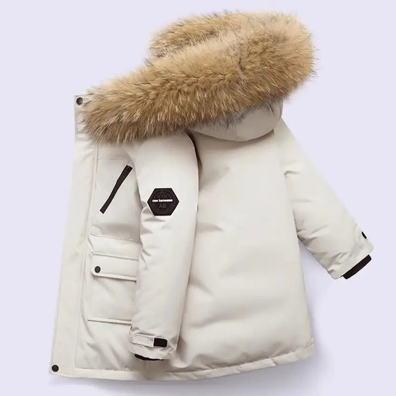 Boys winter coat with hood in cream, side view showing the fluffy hood trim, flap pocket and sleeve patch