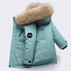 Boys winter coat with hood in teal, side view with fluffy hood trim, sleeve patch and wrist strap