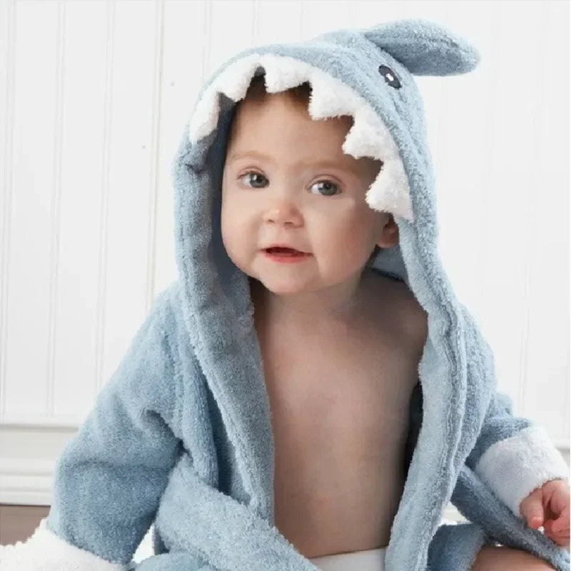 Kids hooded animal bathrobe, Blue Shark design with white teeth on the hood, worn by a baby, close-up front view