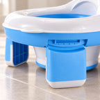 Lumiwee 2-in-1 Travel Potty & Toilet Training Seat: close-up of the fold-out leg, hinge and rubber-coated foot