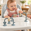 Lumiwee Abacus Suction Cup Toy for High Chairs: baby sliding a ring on the sea blue suction-cup abacus toy with an adult nearby