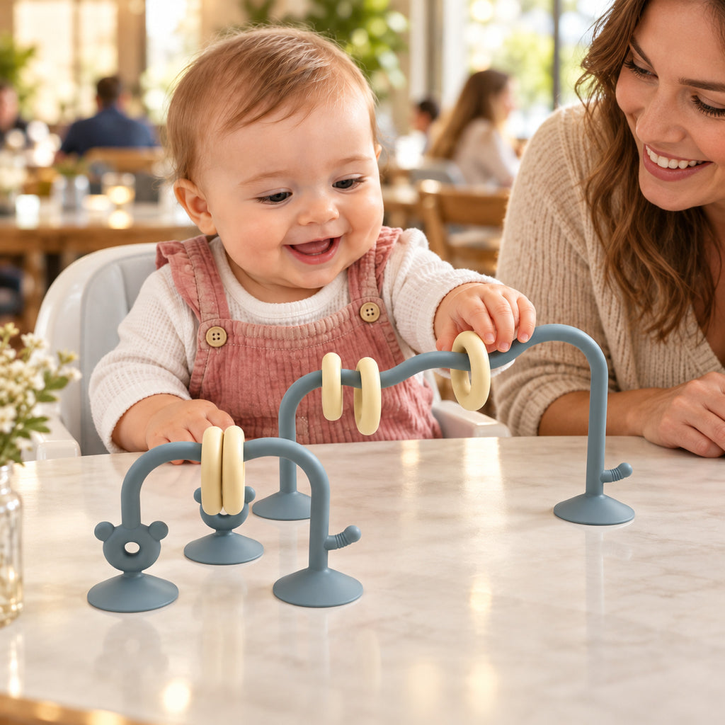 Lumiwee Abacus Suction Cup Toy for High Chairs: baby using the sea blue suction-cup abacus toy at a restaurant table