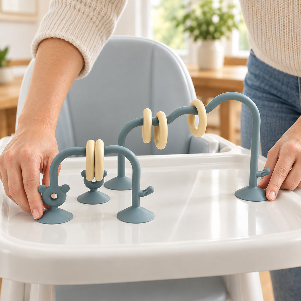 Lumiwee Abacus Suction Cup Toy for High Chairs: adult hands pressing the suction feet onto a high-chair tray