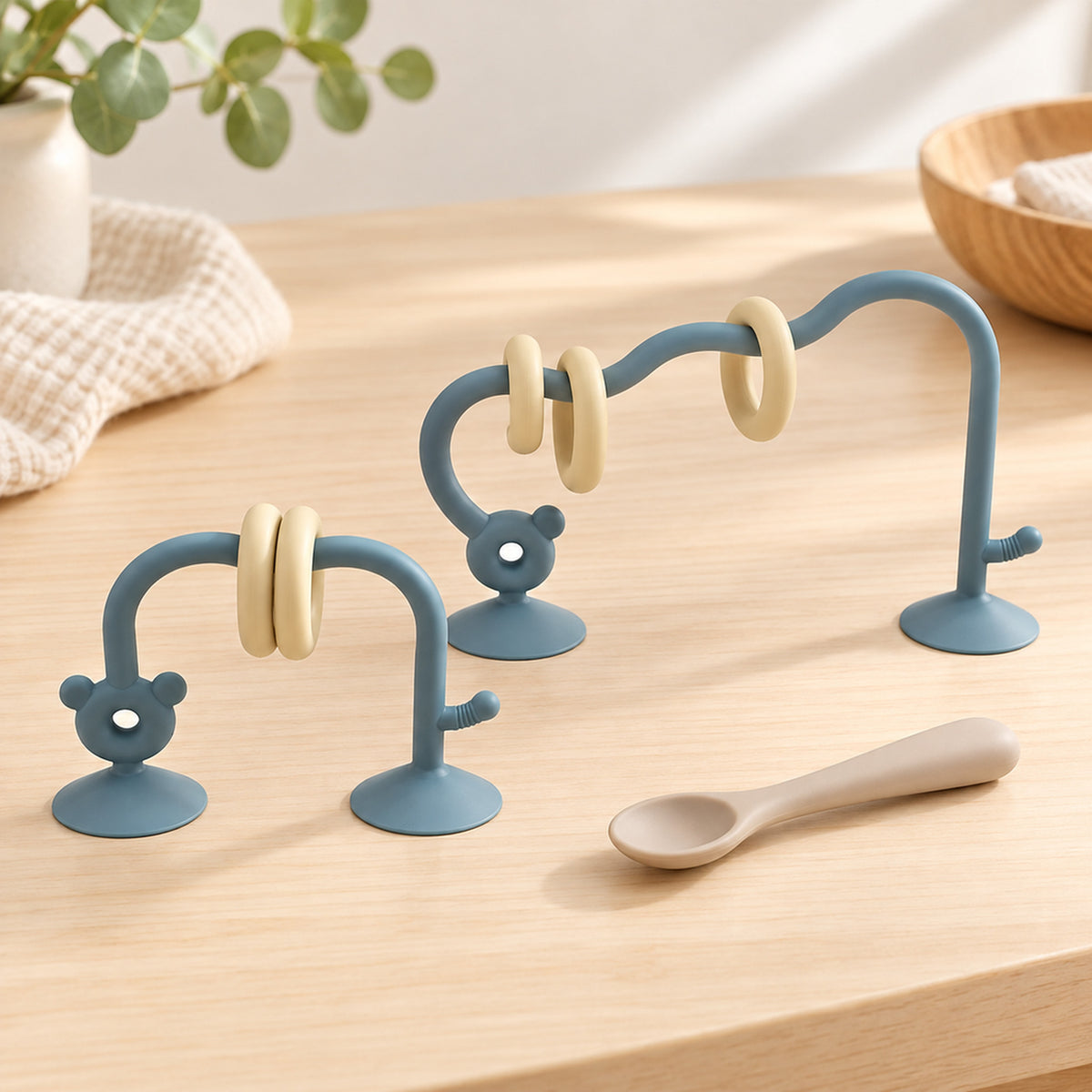 Lumiwee Abacus Suction Cup Toy for High Chairs: two sea blue abacus arches beside a baby spoon for scale