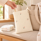 Lumiwee Bloom Quilted Embroidered Diaper Pouch: adult hand lifting the Tulip quilted diaper pouch beside a diaper tote