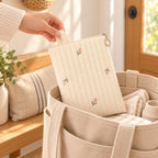 Lumiwee Bloom Quilted Embroidered Diaper Pouch: adult hand placing the Tulip diaper pouch into an open tote
