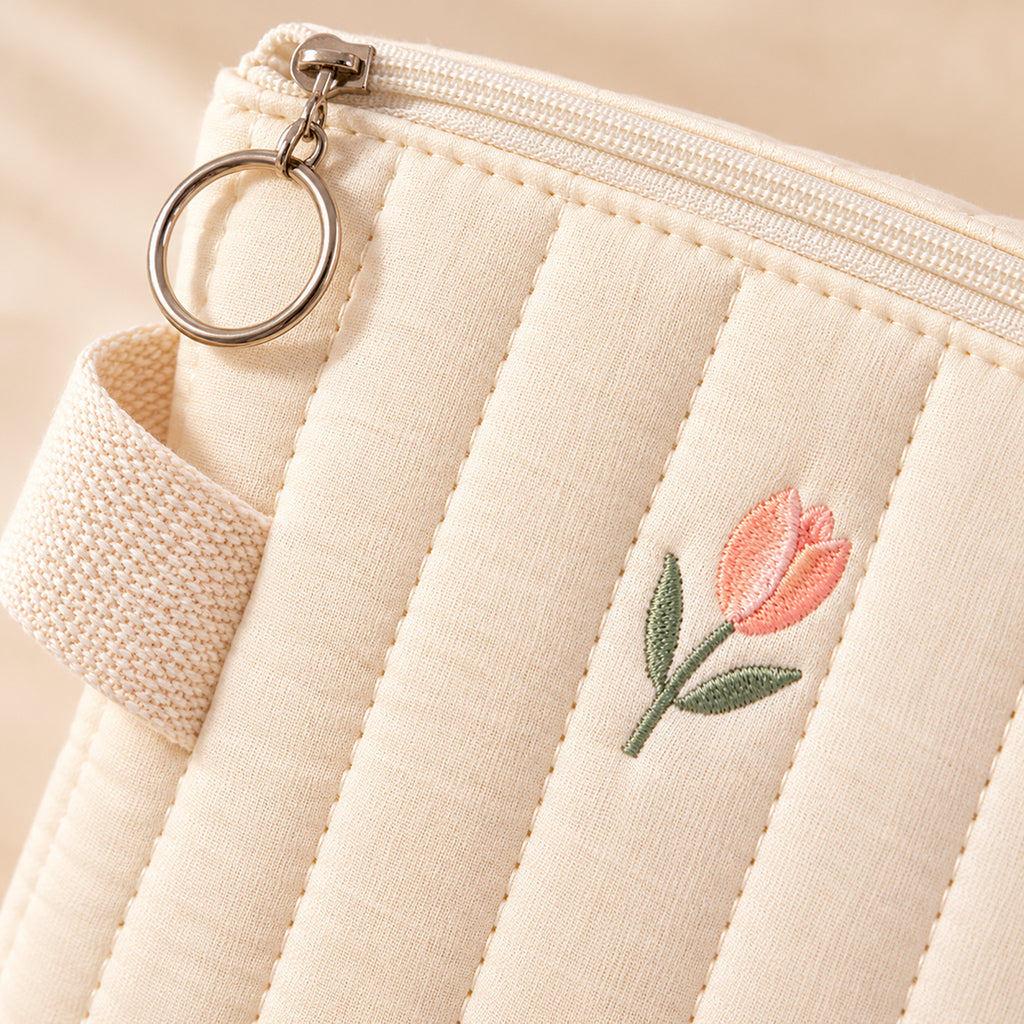Lumiwee Bloom Quilted Embroidered Diaper Pouch: close-up of the quilted cotton, tulip embroidery and ring zipper pull