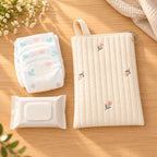 Lumiwee Bloom Quilted Embroidered Diaper Pouch: Tulip diaper pouch beside two diapers and a small wipes pack