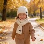 Lumiwee Bow knit kids hat and scarf set: child in the cream bow knit beanie and scarf on an autumn walk