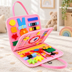 Lumiwee Bramble light pink busy board open on a nursery rug