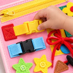 Close-up of buckles, zipper, laces and felt activities on the Lumiwee Bramble busy board