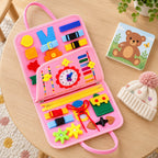 Lumiwee Bramble busy board open beside a board book and knit hat