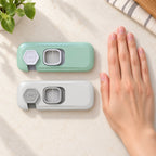 Mint-green and gray Lumiwee fridge locks beside an adult hand for scale