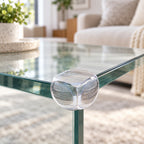 Clear Lumiwee corner guard installed on a glass table in a modern living room
