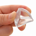 Adult flexing a clear Lumiwee corner guard between thumb and forefinger