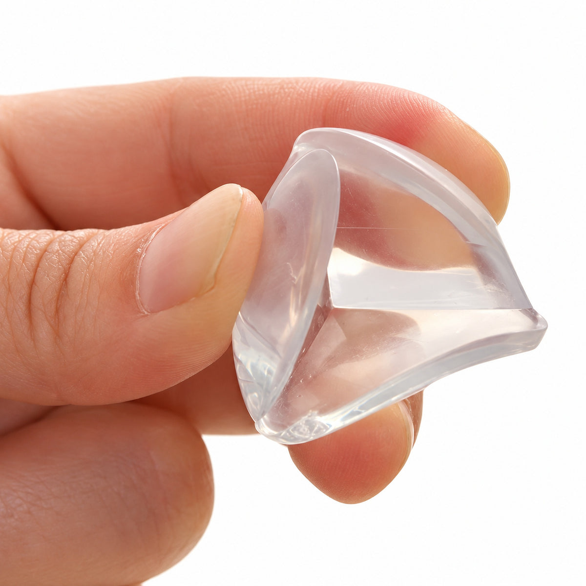 Adult flexing a clear Lumiwee corner guard between thumb and forefinger