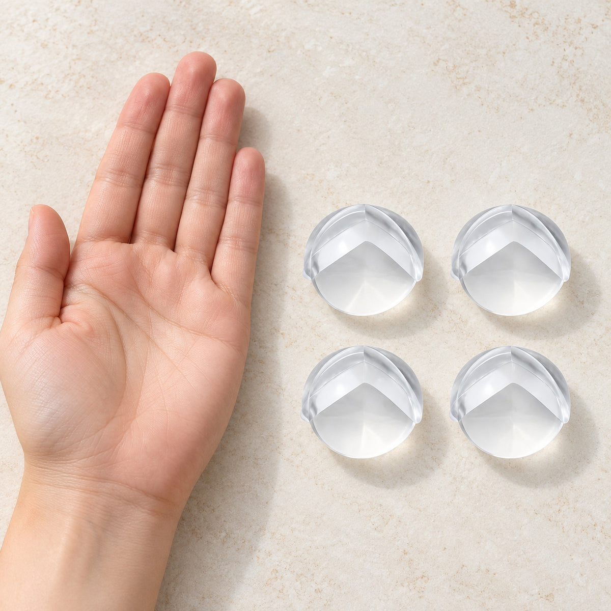 Four clear Lumiwee corner guards beside an adult hand for scale