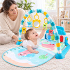 Awake infant reaching for hanging toys during supervised tummy time on the Lumiwee baby gym