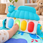Infant foot pressing the glowing green key on the Lumiwee kick piano
