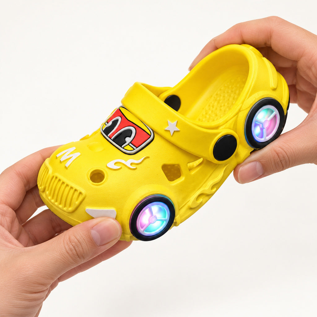Adult hands bending a yellow Lumiwee car clog to show its flexible PVC