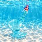 Clear-blue Lumiwee shell open on the pool floor as a mermaid spirals upward