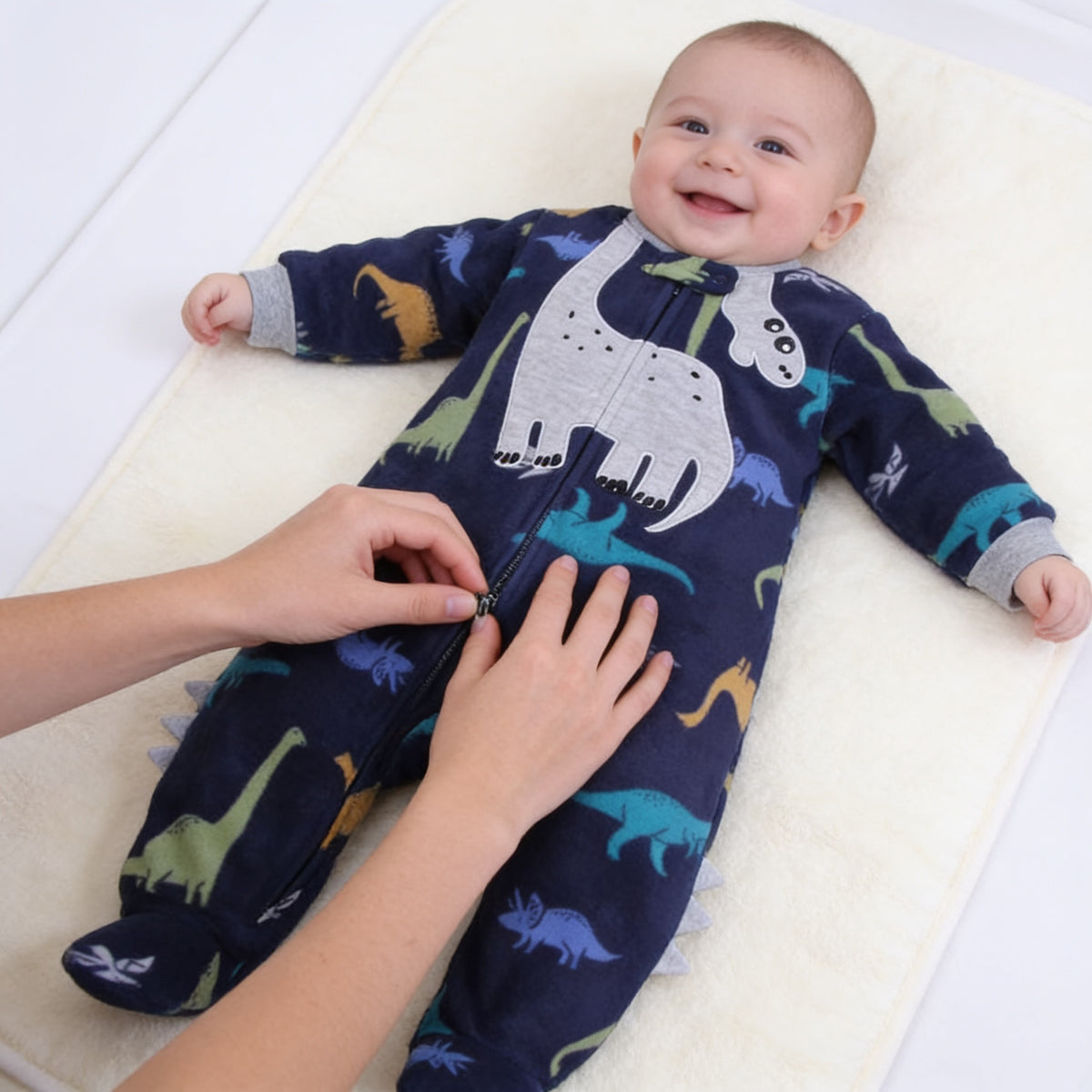 Lumiwee Critter fleece baby romper: zipping the romper up on a smiling baby