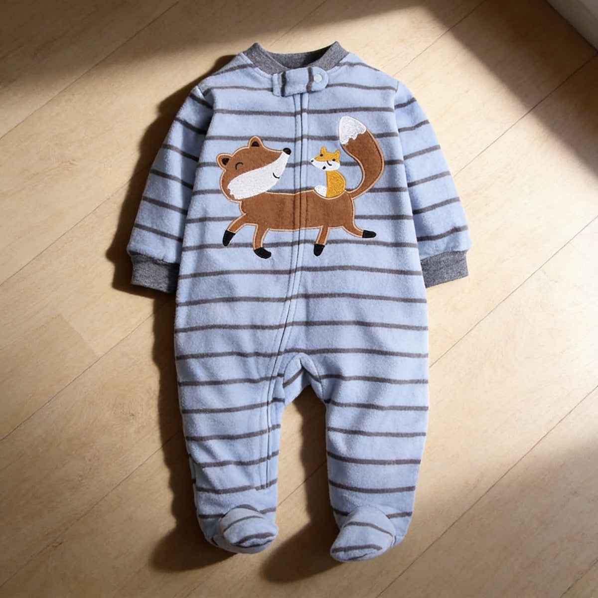 Lumiwee Critter fleece baby romper, Blue Stripe Fox option, in a bright room