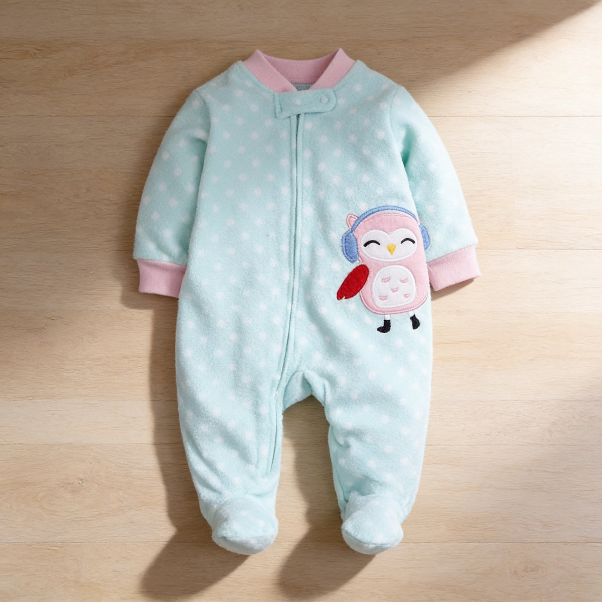 Lumiwee Critter fleece baby romper, Mint Owl option, in a bright room