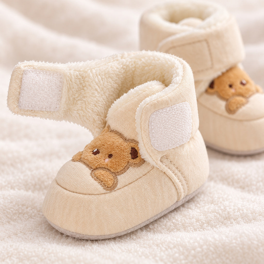 Close-up of the fuzzy cuff and open ankle strap on a Lumiwee Brown Bear baby bootie
