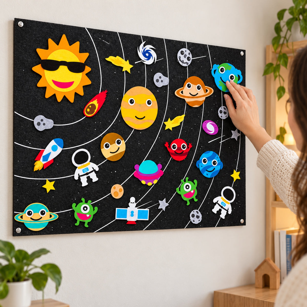 Lumiwee Fable Felt Board: adult presses the Earth piece onto the board