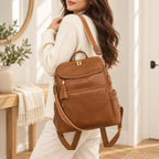 Lumiwee Finch Vegan Leather Backpack Purse: adult carries the brown bag by its shoulder strap