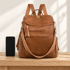 Lumiwee Finch Vegan Leather Backpack Purse: brown bag beside a smartphone for scale