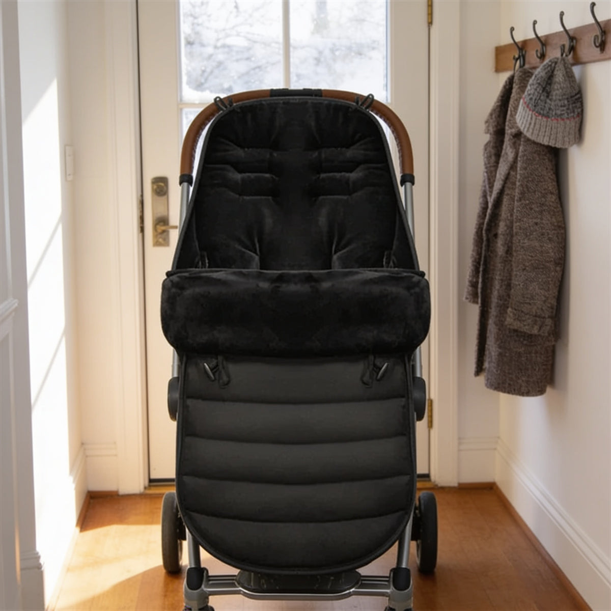 Lumiwee Flurry winter stroller bunting bag: black bunting bag fitted in an empty stroller by the front door
