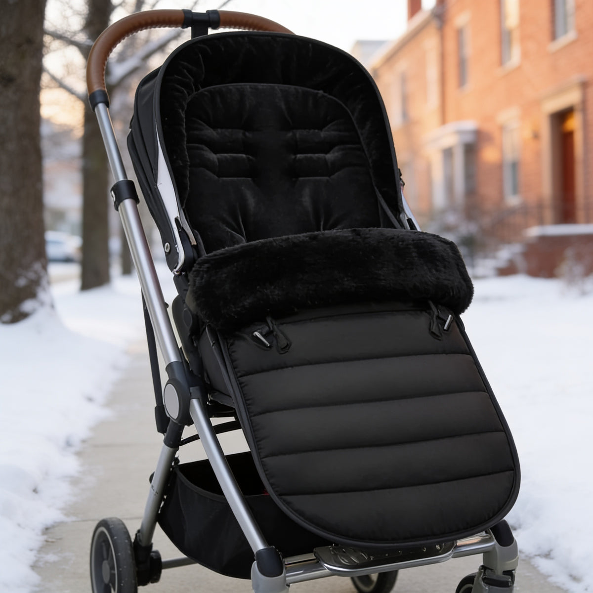 Lumiwee Flurry winter stroller bunting bag: black bunting bag in a stroller on a snowy sidewalk