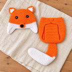 Lumiwee two-piece fox crochet photo outfit laid out on linen