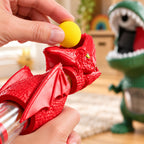 Adult loading a yellow foam ball into the red Gulp launcher