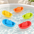Five Lumiwee Harbor colorful tugboat toys floating in a white bathtub