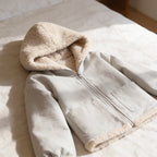 Lumiwee Hearth babywearing maternity jacket: close-up of the sherpa-lined hood, zipper and pocket