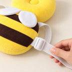 Adult hand adjusting the Bee cushion shoulder strap