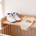 Lumiwee Kick soft-sole baby sneakers: white and blue baby high-top sneakers on a nursery shelf