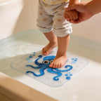 Lumiwee Lagoon kids bath mat: toddler feet stepping onto the mat, holding a hand