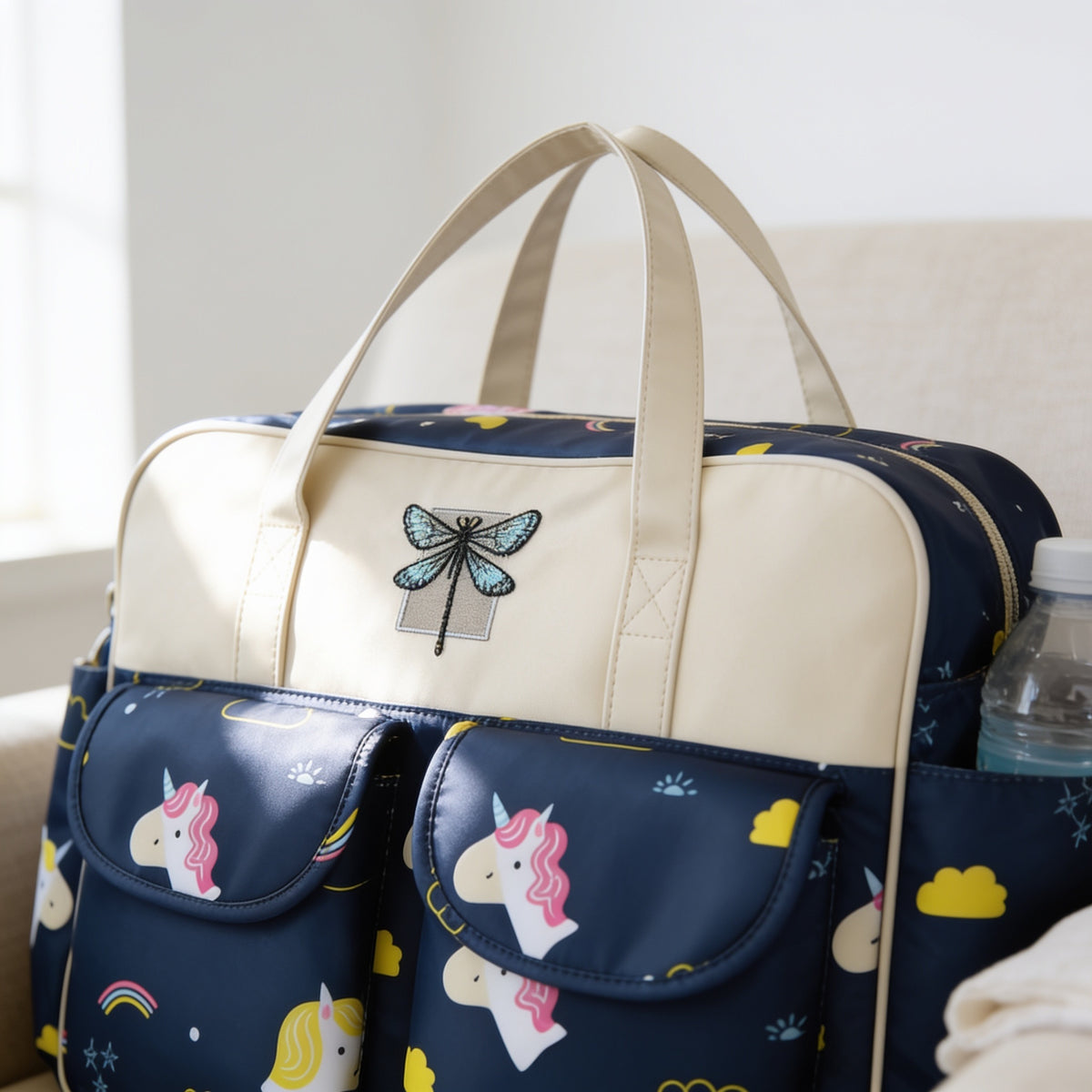 Lumiwee Lark diaper messenger bag: close-up of the front flap pockets and side bottle pocket