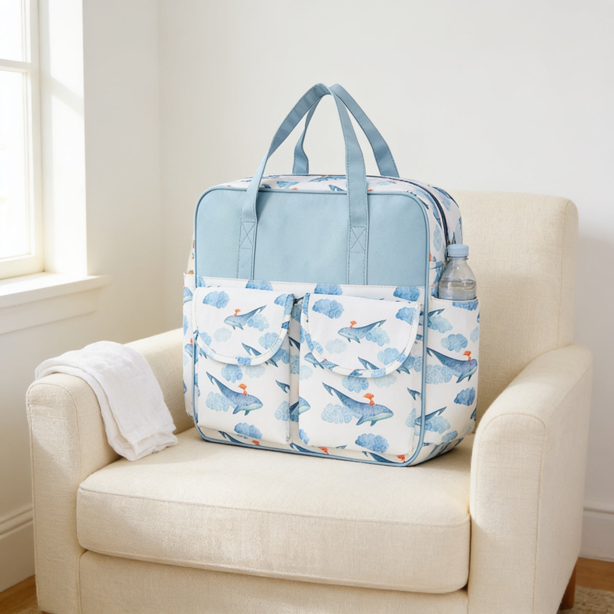 Lumiwee Lark diaper messenger bag, Blue Whale option, in a bright room