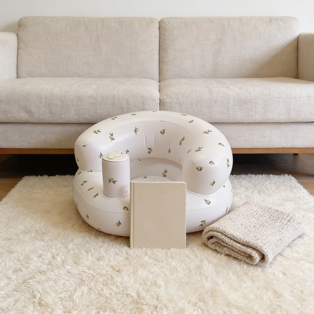 Lumiwee Mallow inflatable baby floor seat: inflatable seat next to a board book for scale