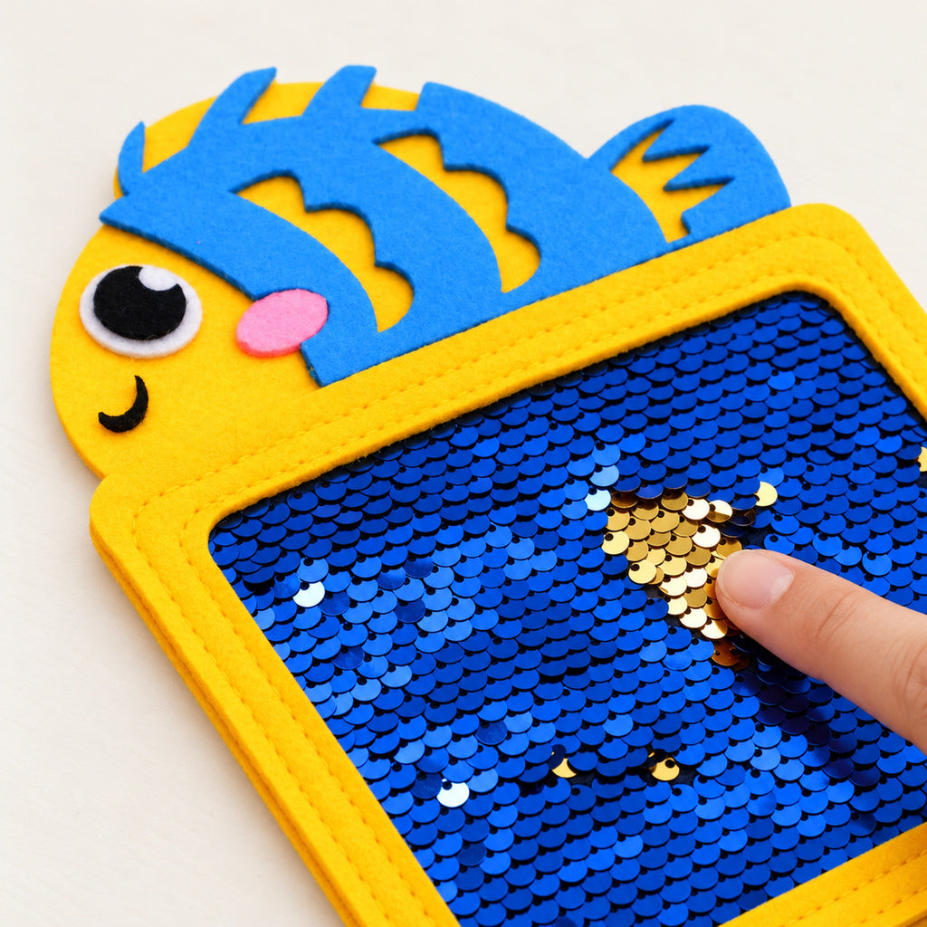 Adult finger flipping sequins on the fish texture mat